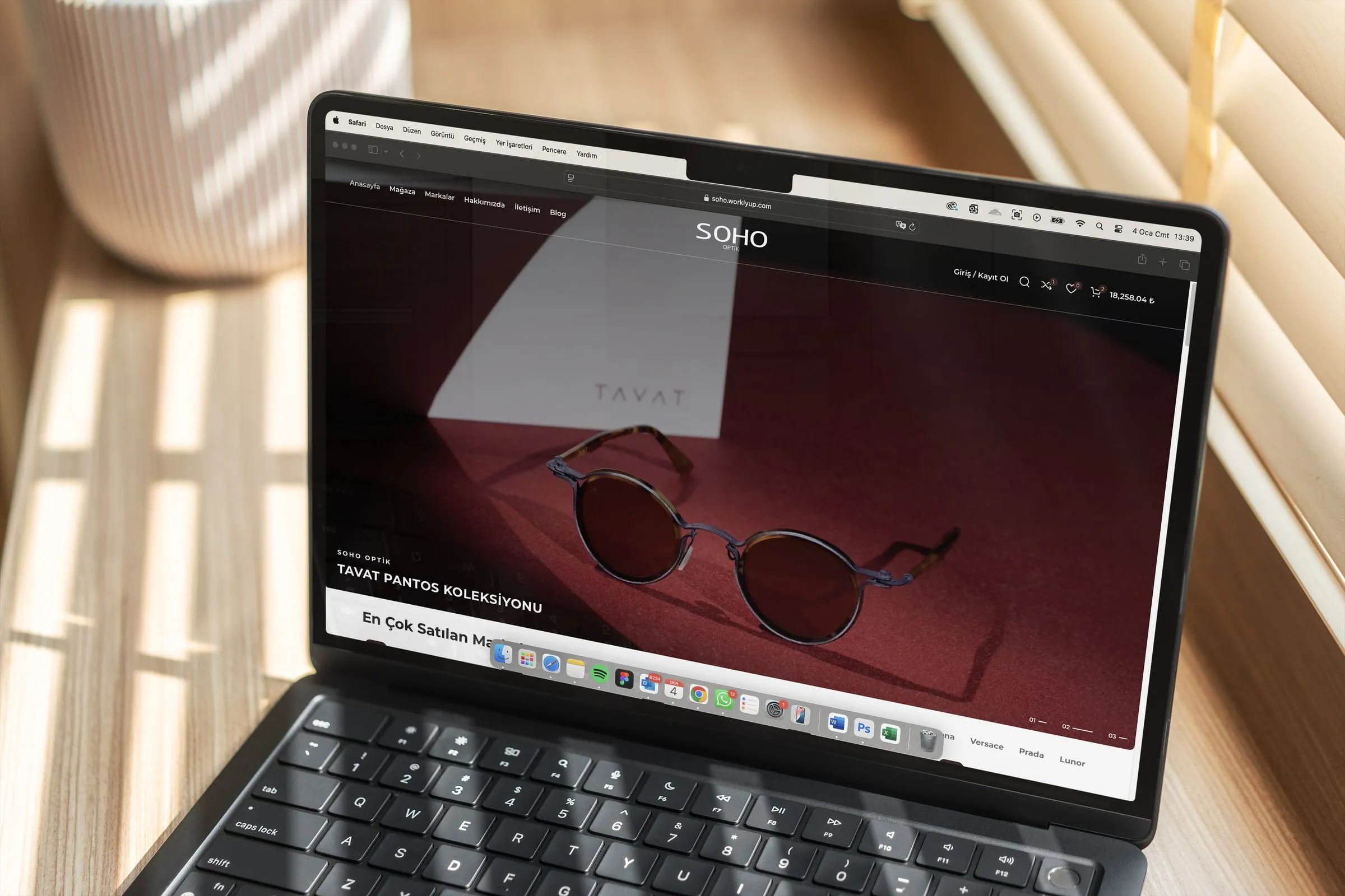 Soho Optik’s online store open on a laptop in a sunlit room, showing the Tavat collection