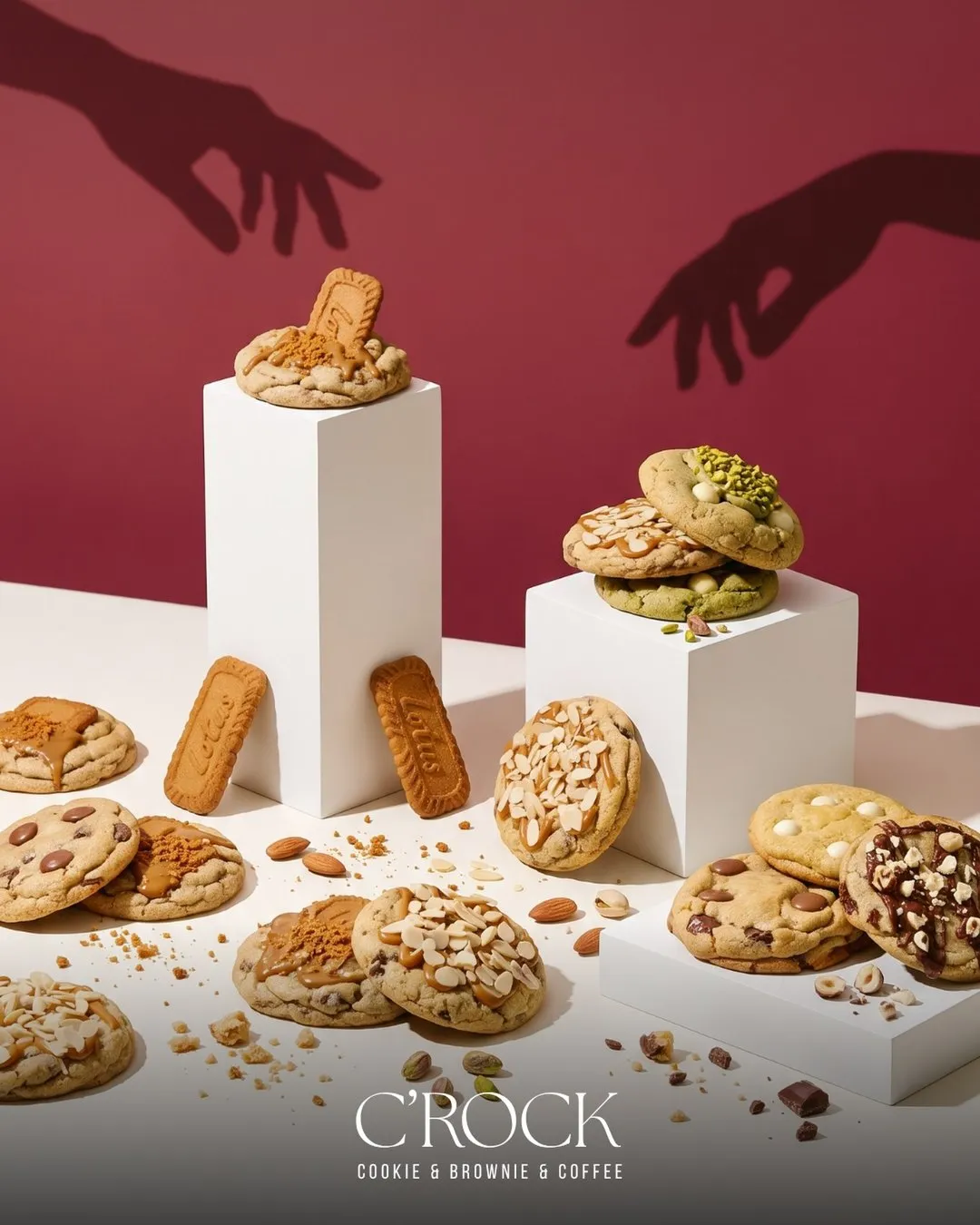Cookies displayed on white plinths against burgundy