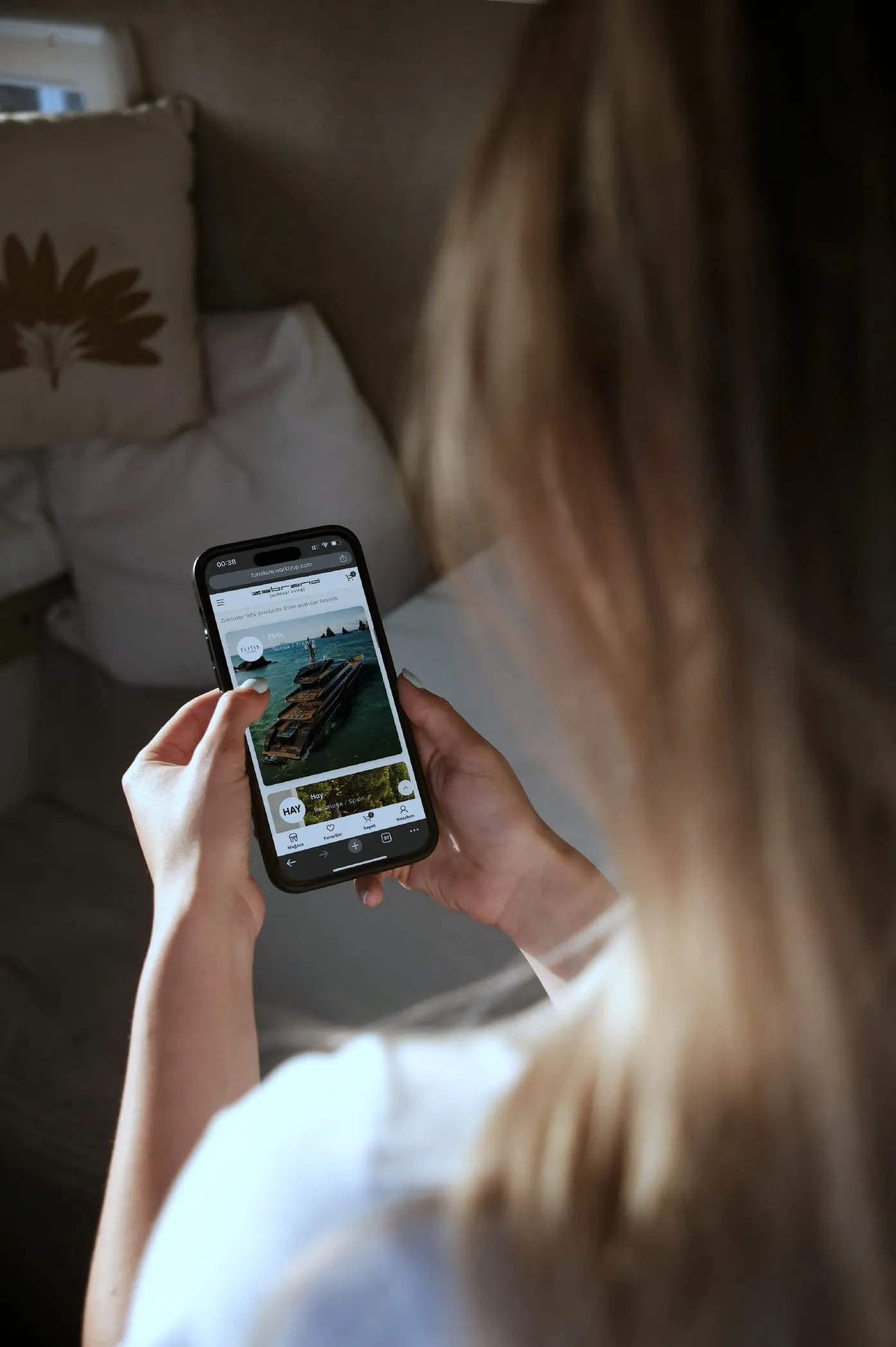 A woman browsing an online store’s product page on her phone in the evening light